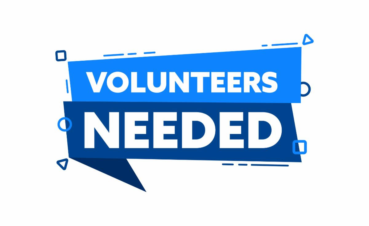 small, two-tone, blue sign that says "volunteers needed"